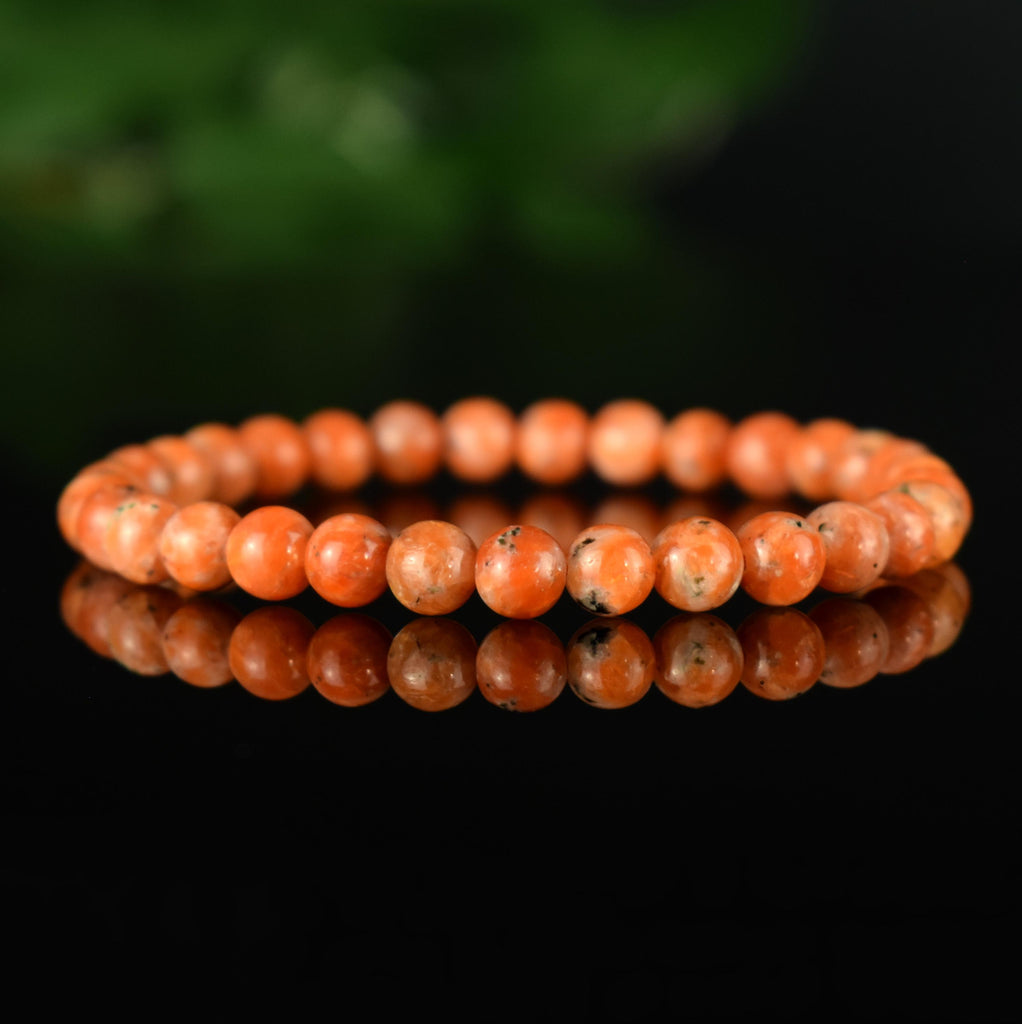 Bracelet Calcite Orange vif perles 6mm qualité AA - inclusions de mica noir
