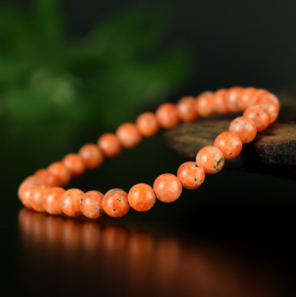 Bracelet Calcite Orange vif perles 6mm qualité AA - inclusions de mica noir