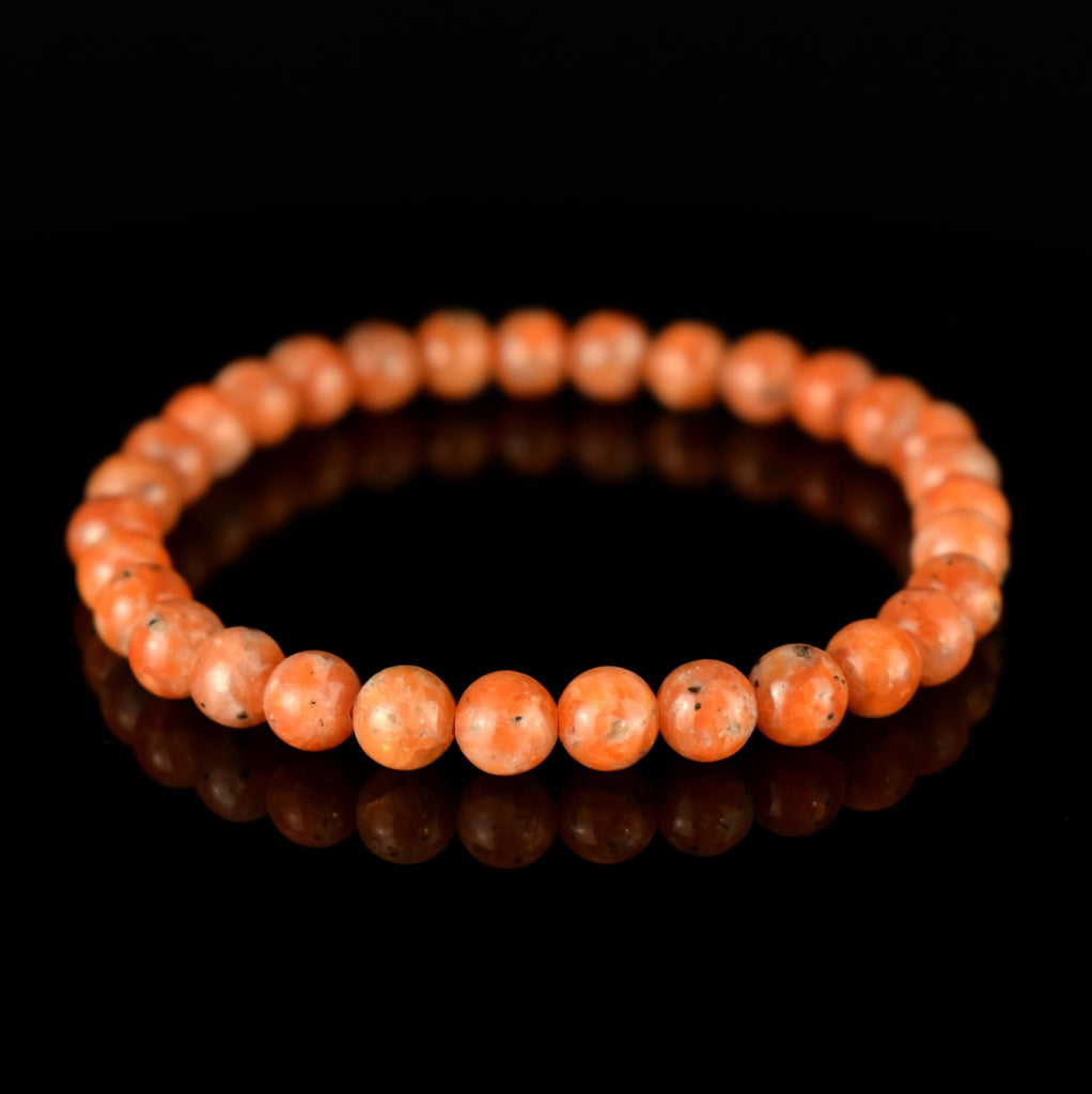 Bracelet Calcite Orange vif perles 6mm qualité AA - inclusions de mica noir