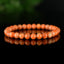 Bracelet Calcite Orange vif perles 6mm qualité AA - inclusions de mica noir