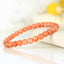 Bracelet Calcite Orange vif perles 6mm qualité AA - inclusions de mica noir