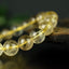Bracelet Quartz Rutile doré 10mm perles rondes AAA