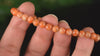 Bracelet Calcite Orange vif perles 6mm qualité AA - inclusions de mica noir